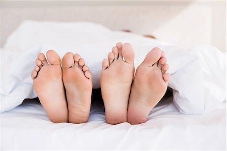 feet bed together - Bare feet of gay couple out from the blanket Stock Photo - Premium Royalty-Free, Code: 6109-08390408