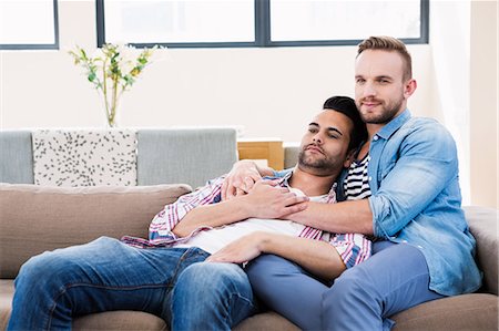 simsearch:6109-08390455,k - Gay couple relaxing on the couch Fotografie stock - Premium Royalty-Free, Codice: 6109-08390552