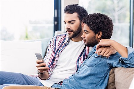 sitting room - Happy gay couple using smartphone Stock Photo - Premium Royalty-Free, Code: 6109-08390502