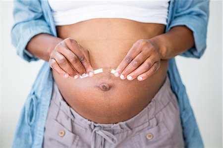 Pregnant woman giving up cigarettes Stock Photo - Premium Royalty-Free, Code: 6109-08395278