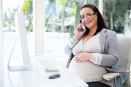 elegant computer - Pregnant businesswoman having a phone call Foto de stock - Sin royalties Premium, Código: 6109-08395360