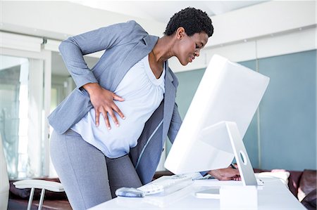 pregnancy black woman - Smiling pregnant businesswoman at work Stock Photo - Premium Royalty-Free, Code: 6109-08395320