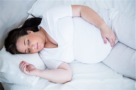 simsearch:6109-07497334,k - Cute pregnant woman resting on her bed Stock Photo - Premium Royalty-Free, Code: 6109-08395496