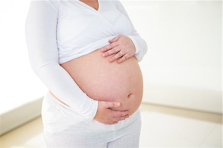 simsearch:6109-08395398,k - Pregnant woman touching her belly Photographie de stock - Premium Libres de Droits, Code: 6109-08395412