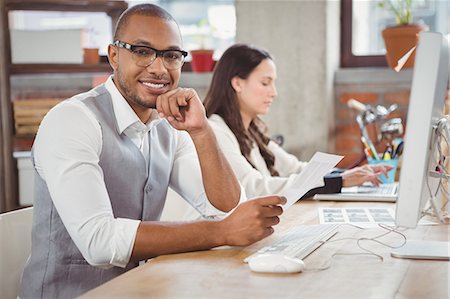 simsearch:6109-06005291,k - Man smiling and holding document at office Stock Photo - Premium Royalty-Free, Code: 6109-08395552