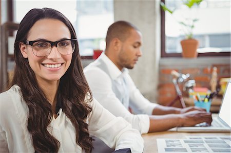 simsearch:6109-06005291,k - Businesswoman smiling at office Stock Photo - Premium Royalty-Free, Code: 6109-08395554