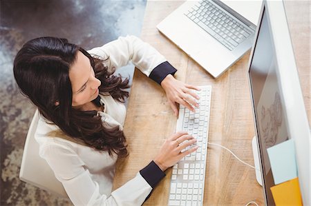 simsearch:6109-08581488,k - High angle view of working businesswoman at office Stock Photo - Premium Royalty-Free, Code: 6109-08395591