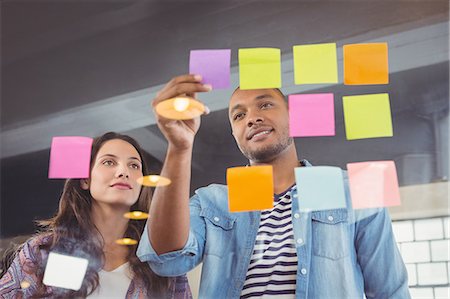 self adhesive note - Creative team colleagues looking at sticky notes Stock Photo - Premium Royalty-Free, Code: 6109-08395662