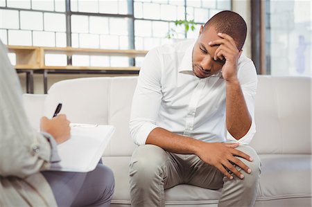 sorrowful man - Upset patient in front of counselor at office Stock Photo - Premium Royalty-Free, Code: 6109-08395622
