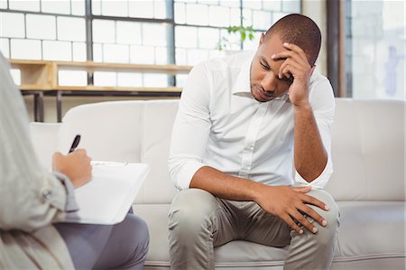 psychotherapy - Upset patient in front of counselor at office Stock Photo - Premium Royalty-Free, Code: 6109-08395622