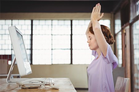 professional woman on phone - Businesswoman meditating in front of computer Stock Photo - Premium Royalty-Free, Code: 6109-08395775