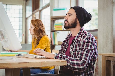 Busy man and woman working at office Stock Photo - Premium Royalty-Free, Code: 6109-08395707