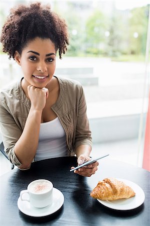 simsearch:6109-08395941,k - Pretty student using her phone in cafe Photographie de stock - Premium Libres de Droits, Code: 6109-08395884