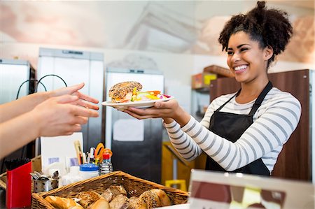 simsearch:6109-08395965,k - Waitress serving lunch to customer Stock Photo - Premium Royalty-Free, Code: 6109-08395964