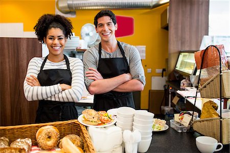 Staff smiling at camera together Foto de stock - Sin royalties Premium, Código: 6109-08395968