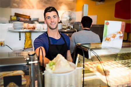 retail sandwich - Handsome waiter offering lunch to camera Stock Photo - Premium Royalty-Free, Code: 6109-08395987