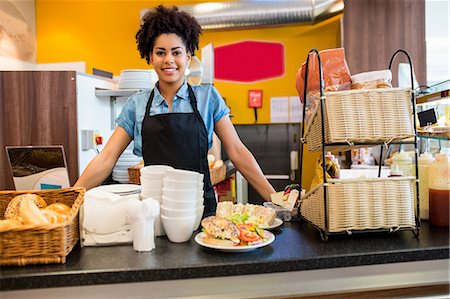 employee and employer - Pretty waitress smiling at camera Stock Photo - Premium Royalty-Free, Code: 6109-08395938
