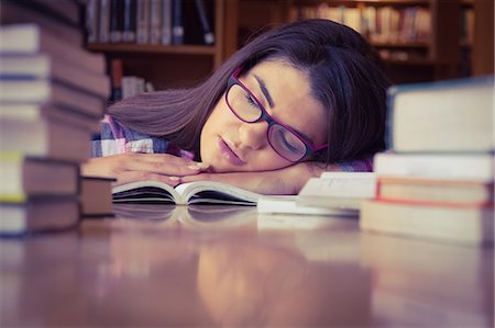 simsearch:632-03424212,k - Female student sleeping with head on book Photographie de stock - Premium Libres de Droits, Code: 6109-08396270