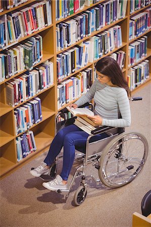 simsearch:6109-07497503,k - Disabled serious female student reading book Stock Photo - Premium Royalty-Free, Code: 6109-08396294