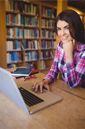 simsearch:6109-07497515,k - Portrait of happy female student using laptop Photographie de stock - Premium Libres de Droits, Code: 6109-08396233