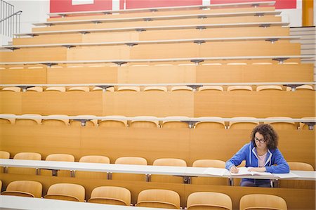 simsearch:6113-07906434,k - Happy student taking notes in lecture Stock Photo - Premium Royalty-Free, Code: 6109-08396386