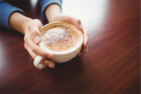 simsearch:6109-08536940,k - Woman having a cappuccino Stock Photo - Premium Royalty-Free, Code: 6109-08396452
