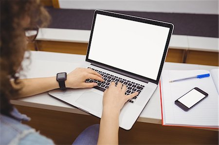 Pretty student in lecture hall with smartwatch Foto de stock - Sin royalties Premium, Código: 6109-08396437