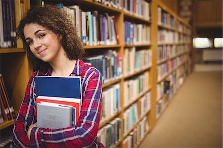 simsearch:6109-08396555,k - Pretty student in the library Photographie de stock - Premium Libres de Droits, Code: 6109-08396543