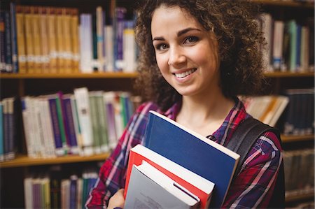 simsearch:6109-08396555,k - Pretty student in the library Photographie de stock - Premium Libres de Droits, Code: 6109-08396545