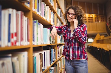 students campus phones - Pretty student in the library taking book Stock Photo - Premium Royalty-Free, Code: 6109-08396568