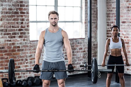 Fit couple lifting weight together Photographie de stock - Premium Libres de Droits, Code: 6109-08396789