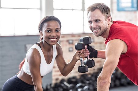 practicing together - Muscular couple lifting weight together Stock Photo - Premium Royalty-Free, Code: 6109-08396855