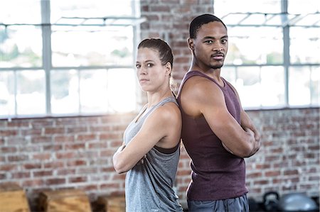 portrait of man at gym - Serious fit couple giving back to back Stock Photo - Premium Royalty-Free, Code: 6109-08396980