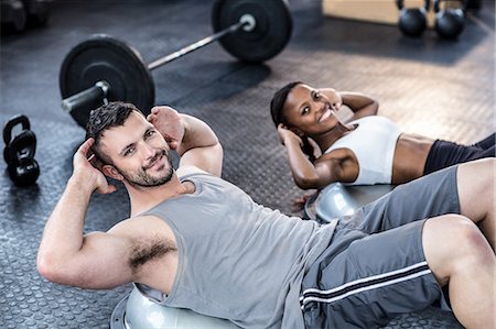 simsearch:6109-08396810,k - Muscular smiling couple doing bosu ball exercises Foto de stock - Sin royalties Premium, Código: 6109-08396903