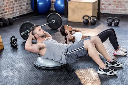 simsearch:6109-08396810,k - Muscular couple doing bosu ball exercises Foto de stock - Sin royalties Premium, Código: 6109-08396902