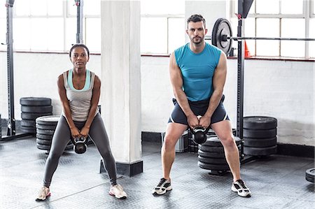 A muscular couple lifting kettlebells Stock Photo - Premium Royalty-Free, Code: 6109-08396926