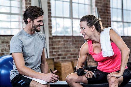 simsearch:6109-07498043,k - Smiling woman doing dumbbell exercises Foto de stock - Sin royalties Premium, Código: 6109-08397173