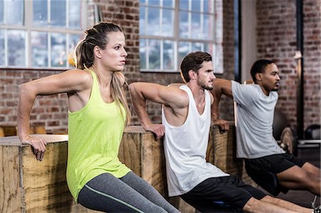 Three young athletes doing exercises Stock Photo - Premium Royalty-Free, Code: 6109-08397198