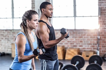 simsearch:6109-08397063,k - Fit couple doing dumbbell exercises Stock Photo - Premium Royalty-Free, Code: 6109-08397106