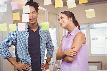 Business people looking at sticky notes in office Stock Photo - Premium Royalty-Free, Code: 6109-08397372