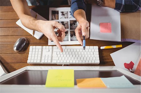 simsearch:6109-08395512,k - Businessmen pointing at computer screen Stock Photo - Premium Royalty-Free, Code: 6109-08397300