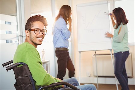 simsearch:6109-08397541,k - Portrait of happy businessman on wheelchair Stock Photo - Premium Royalty-Free, Code: 6109-08397422