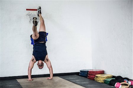 Fit man doing hand stand Stock Photo - Premium Royalty-Free, Code: 6109-08397781