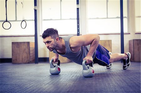 Fit man working out with kettlebells Stock Photo - Premium Royalty-Free, Code: 6109-08397724