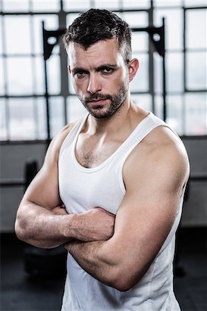 Fit man standing with arms crossed Stock Photo - Premium Royalty-Free, Code: 6109-08397802