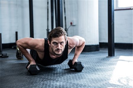 exercise room - Fit man working out with dumbbells Stock Photo - Premium Royalty-Free, Code: 6109-08397963