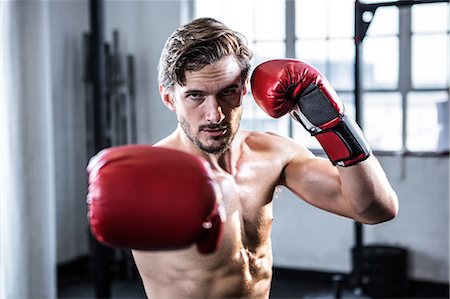 sweaty fighter - Fit shirtless man with boxing gloves Stock Photo - Premium Royalty-Free, Code: 6109-08398048