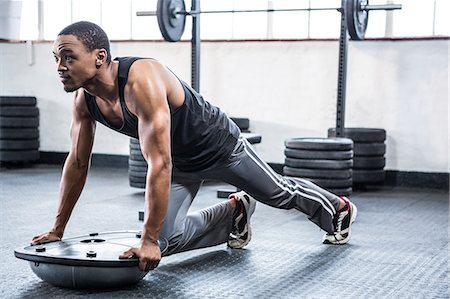 simsearch:6109-08398105,k - Fit man working out with bosu ball Stock Photo - Premium Royalty-Free, Code: 6109-08398092