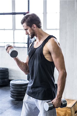 simsearch:6109-08398105,k - Fit man working out with dumbbell Stock Photo - Premium Royalty-Free, Code: 6109-08398022