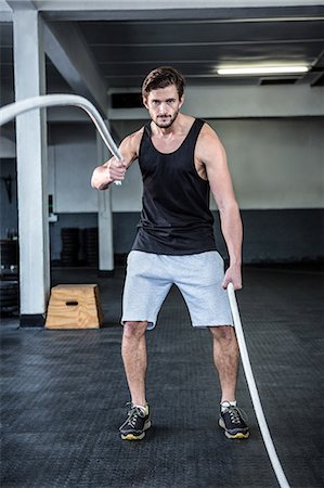 simsearch:6109-08398105,k - Fit man working out with battle ropes Stock Photo - Premium Royalty-Free, Code: 6109-08398024